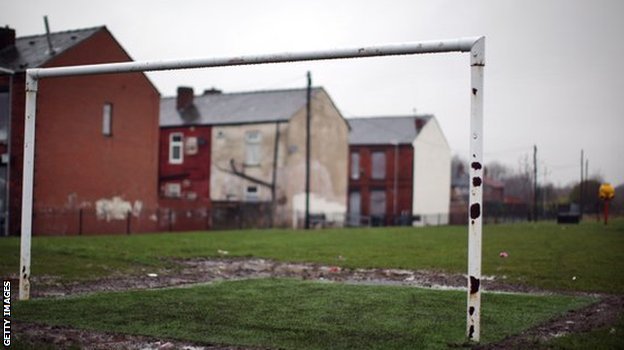 Goalposts on a pitch near homes