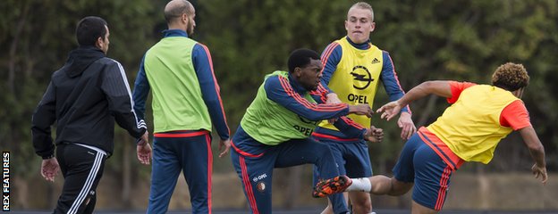 Miquel Nelom fights with Tonny Vilhena as other Feyenoord players and staff look on