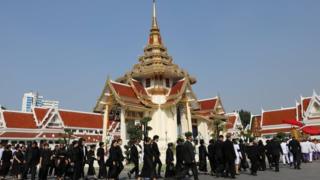 Relatives attend a procession with royal soldiers for the funeral of Vichai Srivaddhanaprabha